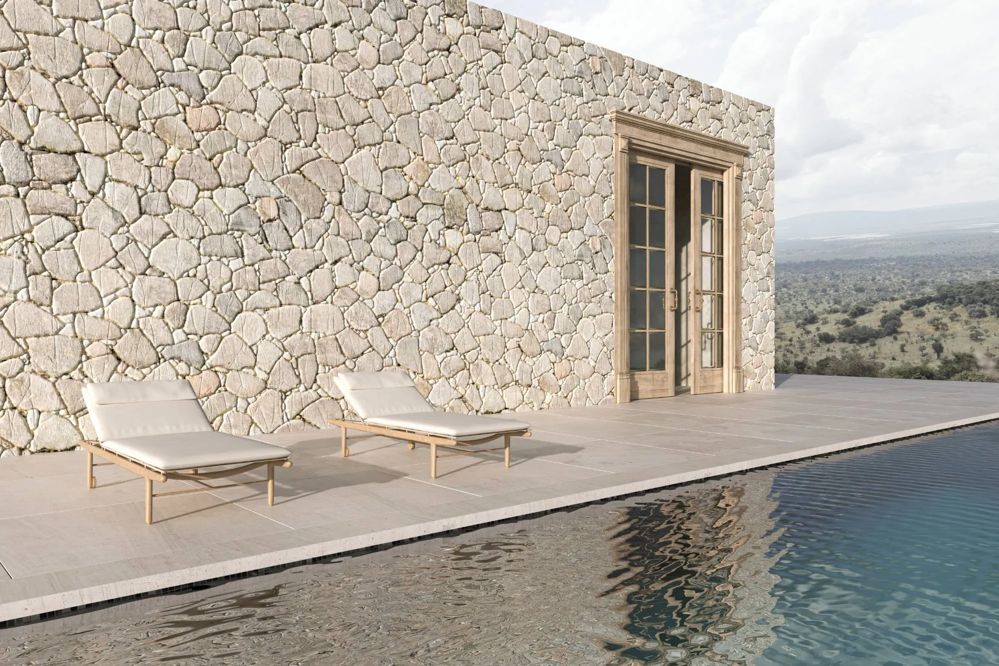 Muro de piedra junto a una piscina con vistas al paisaje